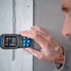Bosch 50m Laser Measure - Horizontal Level Check Close-up of a Bosch 50m laser measure taking a horizontal distance reading on a concrete wall.