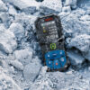 Bosch 50m Laser Measure - Rugged Rubber Housing Ruggedized rubber housing on a Bosch 50m laser measure sitting in construction site debris.