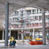 Bosch 50m Laser Measure - Vertical Measurement Measuring vertical distance with a high-visibility green beam laser on a large scale construction project.