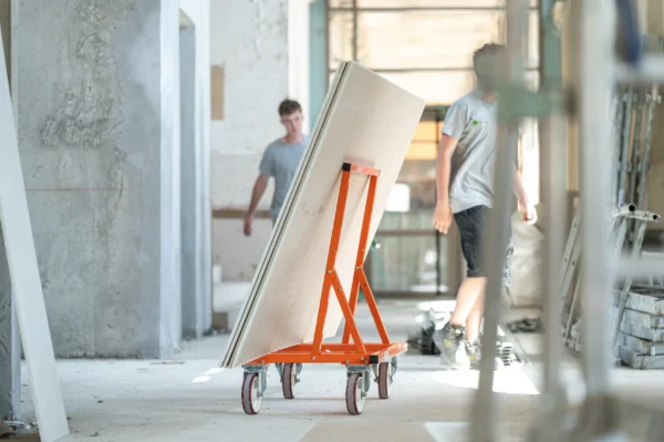 Mondelin 900kg Board Trolley – End Profile Corridor View End-on view showing the slim profile of the Mondelin 900kg board trolley carrying large sheets down a hallway, available for tool hire from Weller Hire.