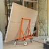 Mondelin 900kg Board Trolley – On-Site Frame Close-Up Close-up of the heavy-duty orange Mondelin 900kg board trolley supporting plasterboard sheets on site, available to rent from Weller Hire.