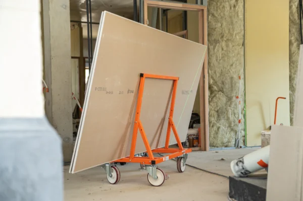 Mondelin 900kg Board Trolley – On-Site Frame Close-Up Close-up of the heavy-duty orange Mondelin 900kg board trolley supporting plasterboard sheets on site, available to rent from Weller Hire.